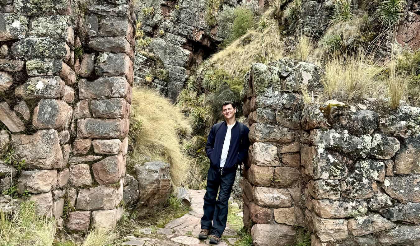 Nomade Matt posant près de vieilles ruines Inca lors de la randonnée au Pérou